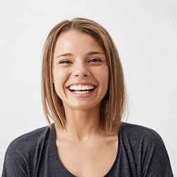 smiling young woman with dental implants in Owings Mills 