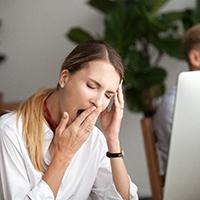 Woman with sleep apnea tired at work