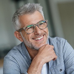 gray-haired man smiling with dentures in Owings Mills 