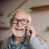 Man with dental implants in Owings Mills, MD talking on phone