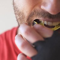 Man inserting a mouthguard 