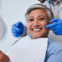 Dentist pointing to his patient’s bright smile 