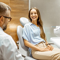 Female patient smiling at dentist at dental appointment