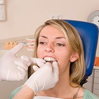 Dentist checking fit of Invisalign tray