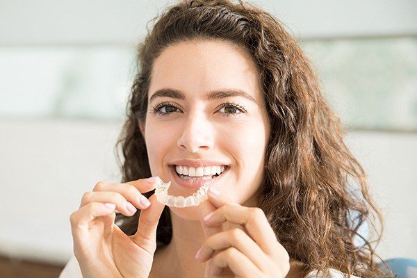 woman holding invisalign tray