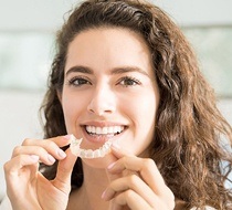 woman holding invisalign tray