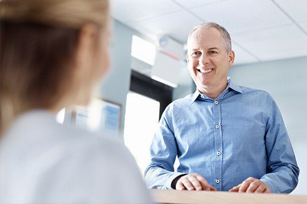 man scheduling dental appointment