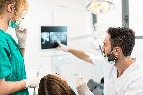 Dentist pointing at x-ray