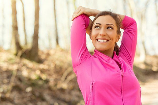 Woman stretches outside