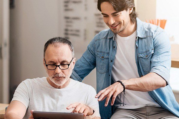 two men looking at dental forms