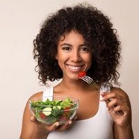 Woman eating salad in Owing Mills