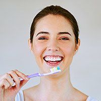 Woman brushing teeth