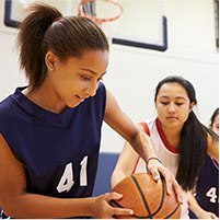 Teen girls playing basketball