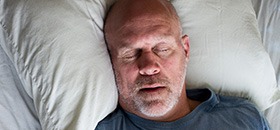 Man sleeping soundly in bed