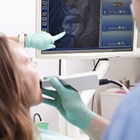 Dentist and patient looking intraoral photos