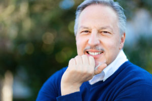 older man smiling outdoors