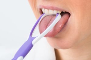 a person cleaning their tongue