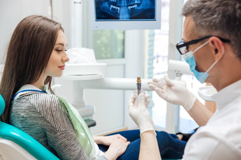Implant dentist discussing dental implants with patient