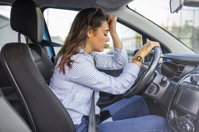 Tired woman resting in her car