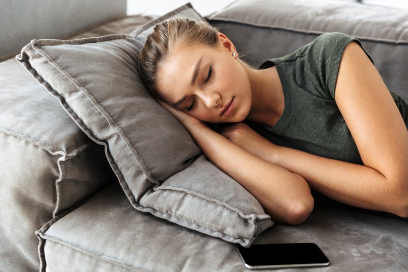 Woman napping on her couch