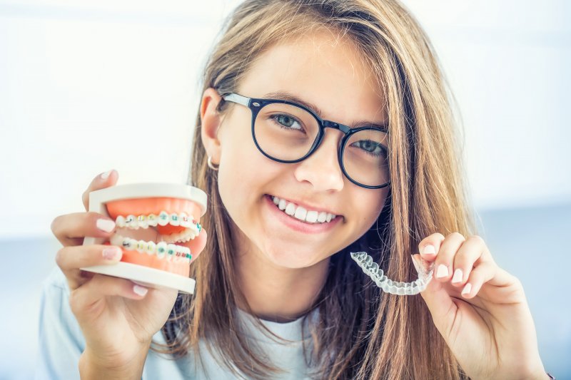 Young girl holding Invisalign tray