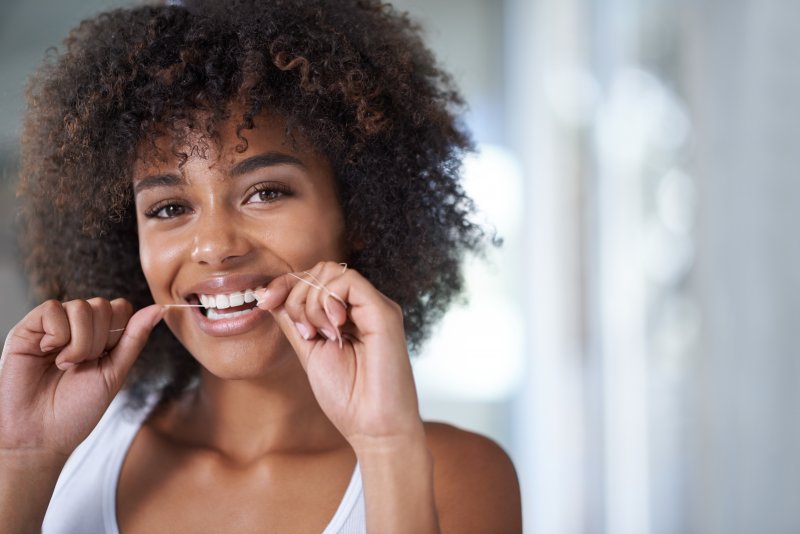 closeup of woman flossing