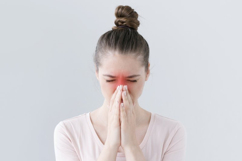 Young woman with pain in her nose