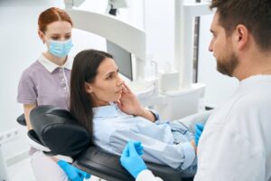 Dentist and patient talking about TMJ disorder