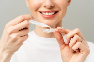 Woman using professional whitening kit