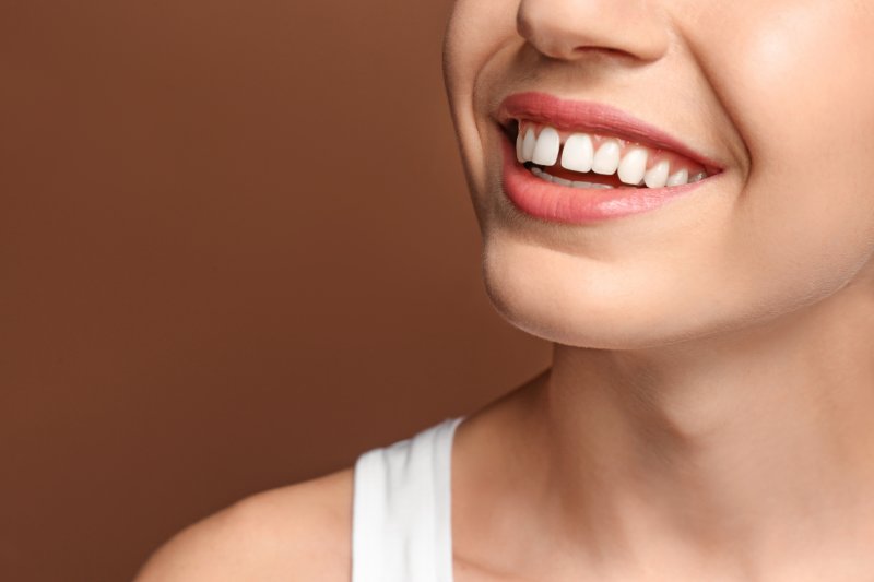 A smiling woman revealing a gap between her two front teeth