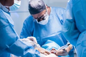 Dentist performing dental implant surgery.